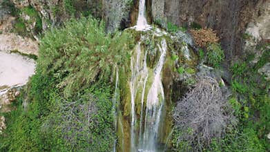 Aerial shot shows waterfall, hiking destination in Turkey, amidst mountains and greenery. Captures waterfall, hiking