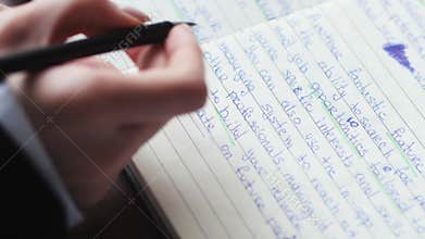 Hands, writing and book of woman with a pen in study journal, diary or notebook at home. Hand of a creative female