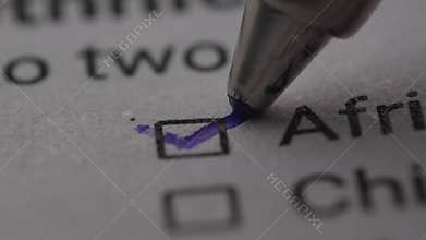 Pen mark a Checkbox labeled &#x27;African American&#x27; on a document.