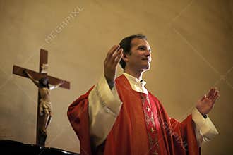 Catholic priest on altar praying during mass