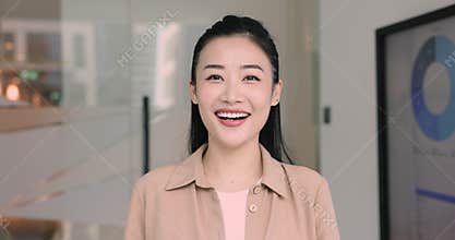 Asian female employee, financial or sales analyst posing in office