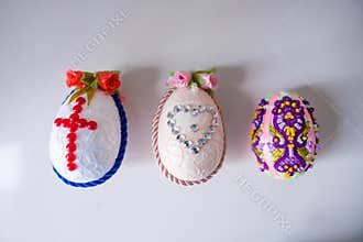 Easter decoration handmade Easter eggs with flowers, cross, heart and beads