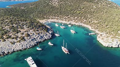 Azure water harbor with boats docked, surrounded by natural landscape, in Bodrum Turkiye