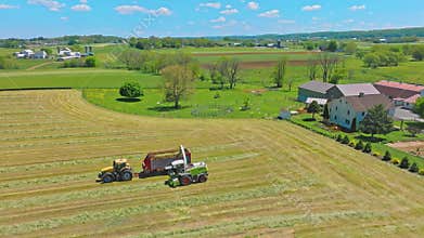 Harvest Dance: Tractors Bale Hay in Golden Fields with azure skies
