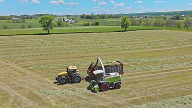 Harvest Dance: Tractors Bale Hay in Golden Fields with azure skies