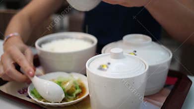 Woman hands close and open pots with hot meat,