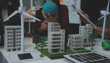 Business people having consultation about wind energy at company office. Business team discussing about windmill and alternative