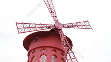 red mill with rotating blades on famous Parisian