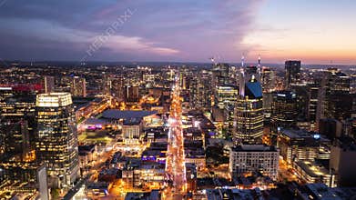 Night hyperlapse of traffic in Nashville's downtown streets captured from above during dusk. Fly Through aerial shot