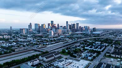 Stunning aerial views of Houston, Texas at dusk, showcasing the city's skyline, highways, and urban landscape under