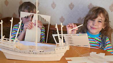 boy and girl together constructing toy model of