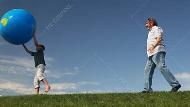 senior with his grandson throw large inflatable
