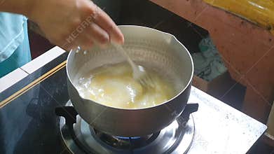 Stirring to mixed egg or beaten egg or whisked egg for cooking scramble egg.