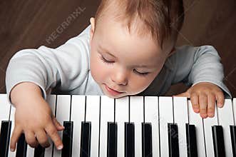 Baby play music on piano keyboard