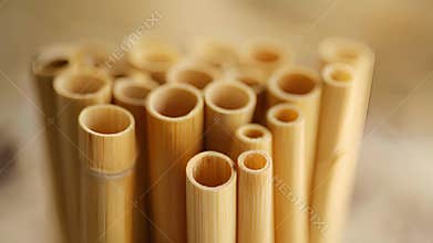 A stack of bamboo straws in various lengths perfect for use in different sized cups and glasses