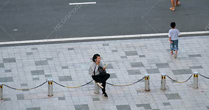 Phu Quoc Island Vietnam 06.16.2024 woman and man rest sitting on the road there are no benches and the traveler began to