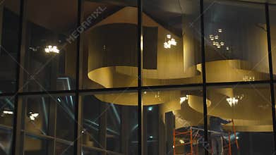 Volumetric ceiling decor visible through glass facade