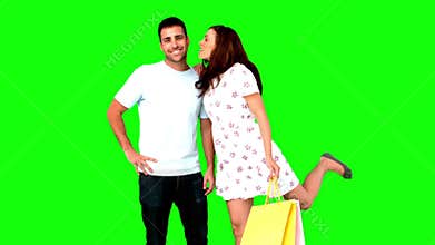 Man being kissed on his cheek by his girlfriend