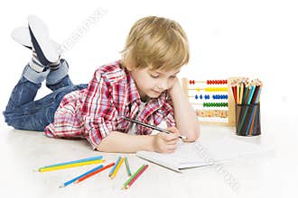 School boy writing exercise in notebook. Schoolboy do homework