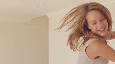 Pretty woman jumping on bed