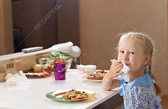Beautiful blond girl wiping her mouth on a napkin