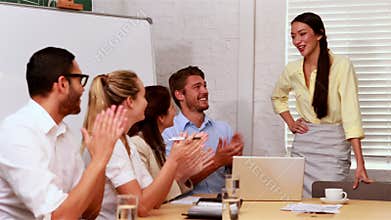Casual business team clapping at presentation