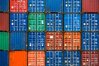 Four vertical rows of shipping containers