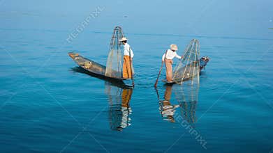 Burma, Inle Lake. The traditional way of fishing. Fishermen on boats with fish-traps
