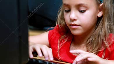 Little girl smiling at camera during computer class