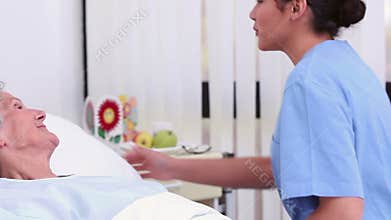 Nurse holding the hand of a senior patient