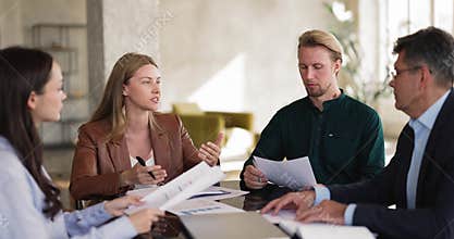 Team leader explains business strategy, guides colleagues through project details