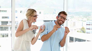 Happy business team celebrating with dance