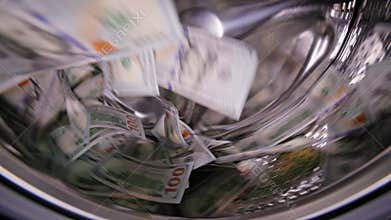 United States Dollar banknotes bouncing around inside washing machine
