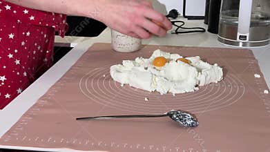 Close-up view of hands mixing cottage cheese dough on