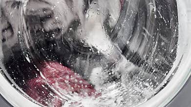 Close-up view of a washing machine drum behind a
