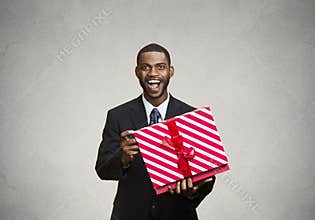 Happy, surprised man receiving gift from someone