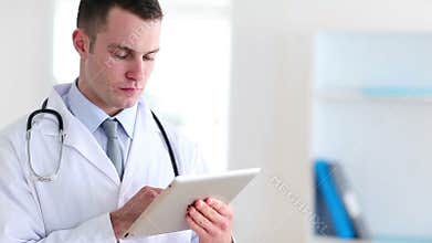 Young doctor using a tablet pc