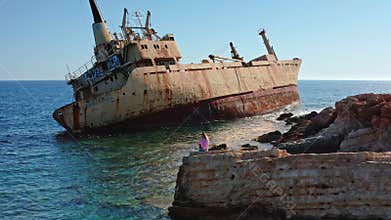 Woman viewing Edro III shipwreck at Peyia coast in Cyprus