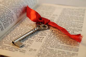Opened Bible with a Key
