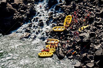 A group of people white water rafting on the Zambezi River.