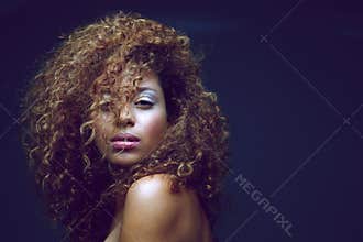 Beautiful female fashion model with curly hair