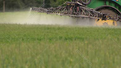 Follow tractor spray field plants with chemical pesticide