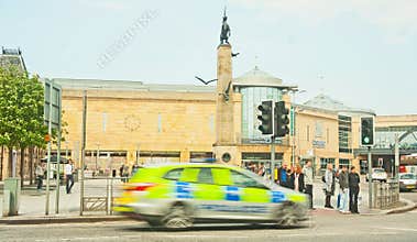 Blurred police car in city center