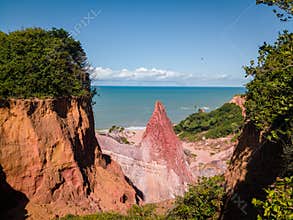 Dramatic view of the red rock canyon and cliffs opening to the turquoise sea at Coqueirinho Beach, ParaÃ­ba, a Brazil travel gem