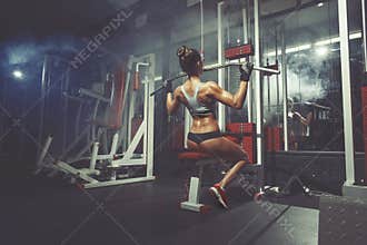Fitness sport woman lifts in the gym