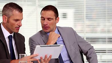 Businessmen working on a tablet
