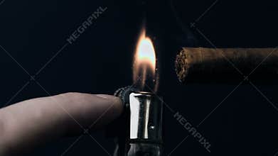 Hand lighting a cigar