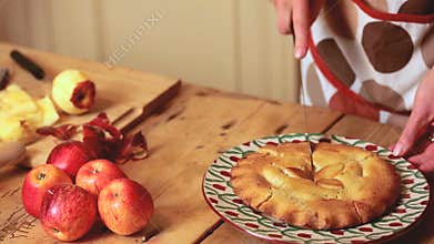 Close up on womans hands cutting a pie