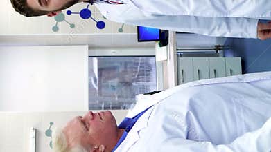 Two male scientists greet each other at the laboratory
