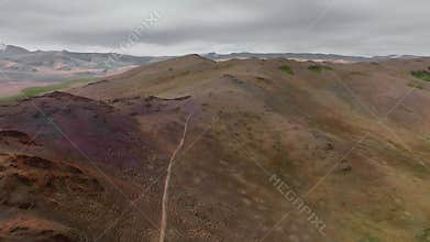 stunning aerial view of the red-soil hills of the steppe region. Cinematic drone footage. Discover the beauty of the Earth